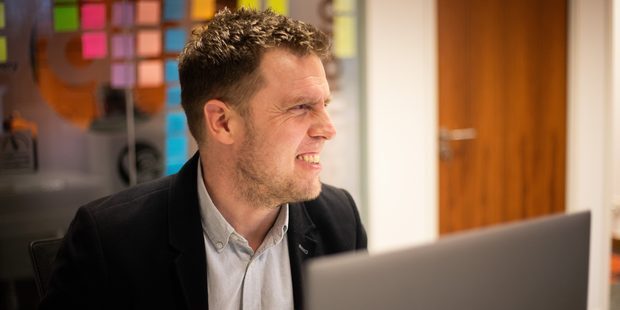Aztech consultant working at a laptop in the office